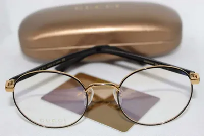 Armazón oftálmico Gucci redondo metálico dorado y negro